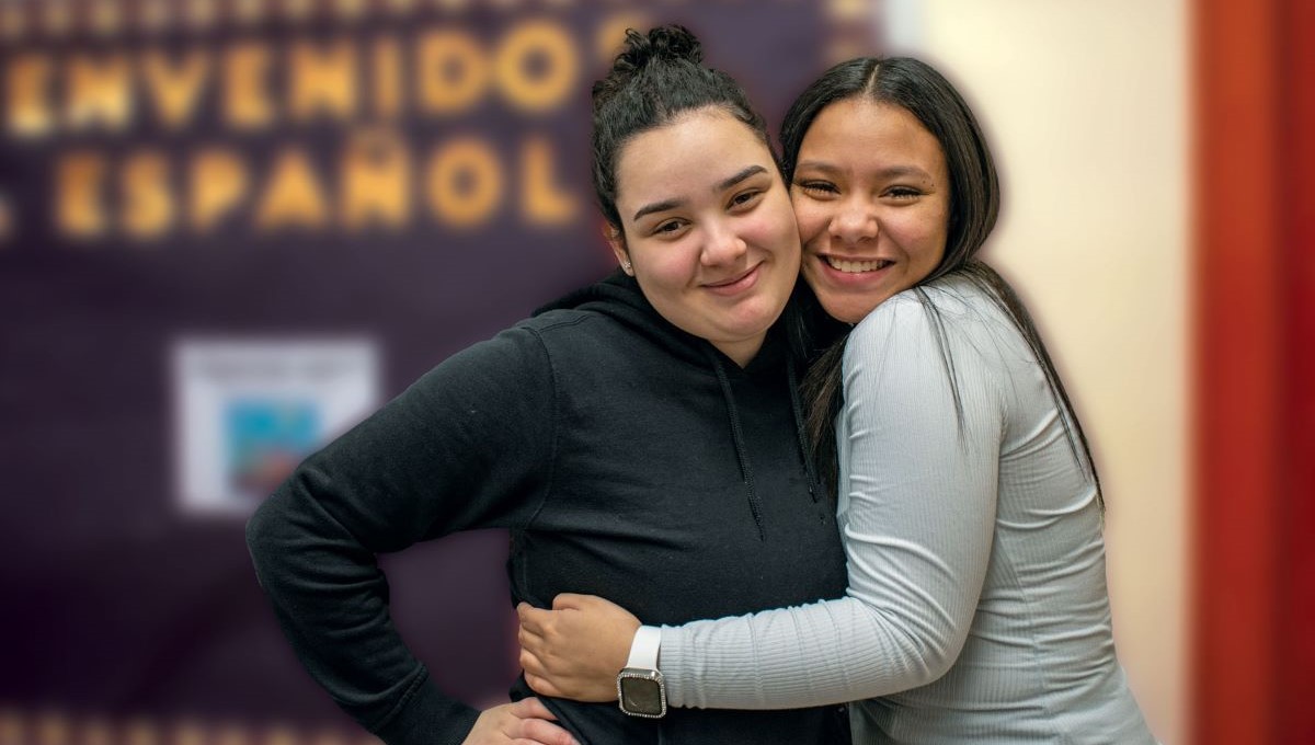 Two happy girls hugging